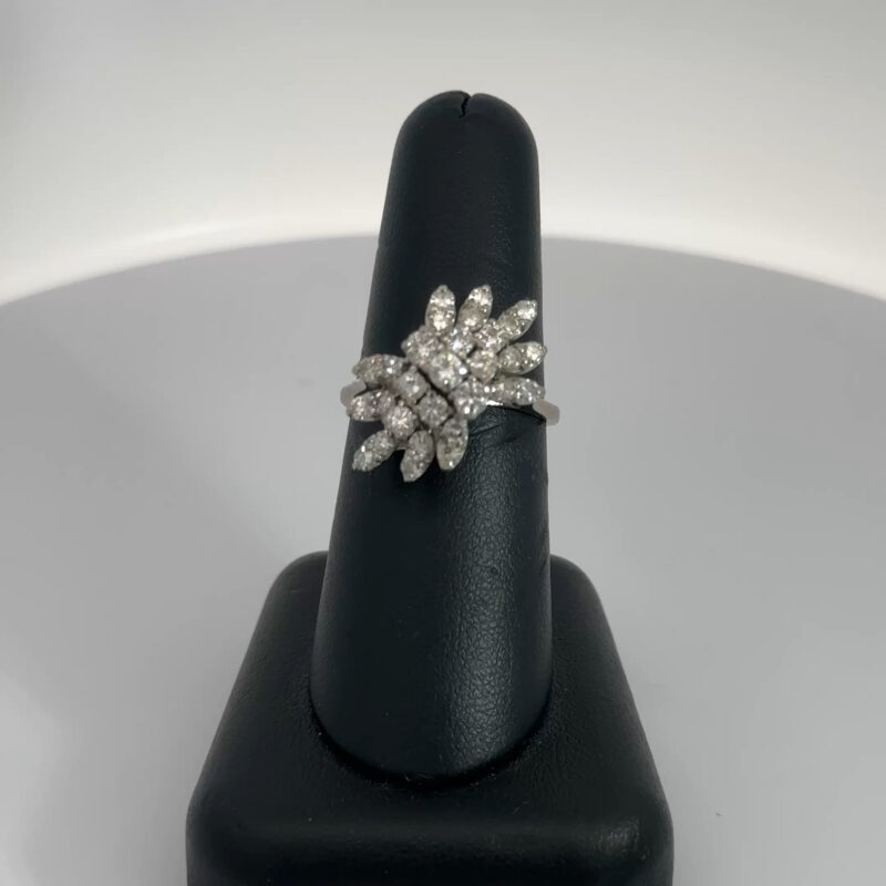 Close-up of John's Loan & Jewelry 14k white gold ladies ring, featuring a natural diamond cluster. The diamonds are arranged in a floral spray design, totaling 1.5ct TW.