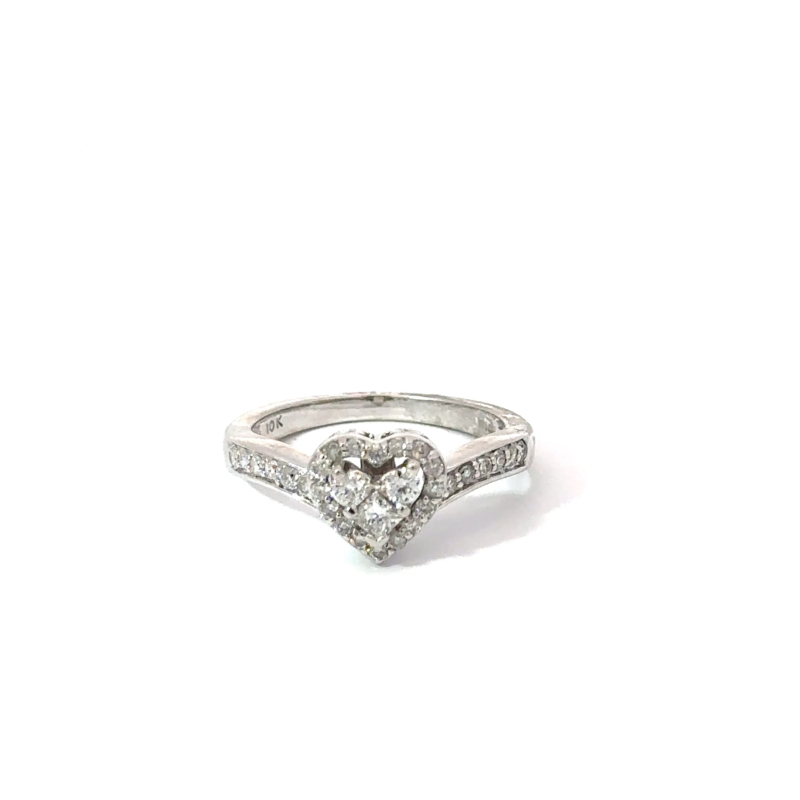Ladies' 10k white gold ring featuring a 'heart' shaped diamond cluster, available at John's Loan & Jewelry, Las Vegas. Detailed jewelry shot on a white table.