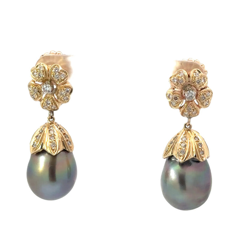 Close-up image of John's Loan & Jewelry 14k gold dangle earrings, each featuring a floral diamond cluster above a textured gold cap and a lustrous black pearl drop.