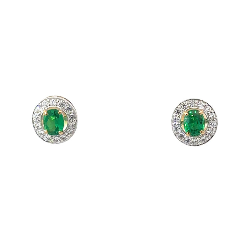 Pair of 18k gold earrings from John's Loan & Jewelry featuring round-cut green stone centers, surrounded by a halo of round-cut white sapphires, displayed on a white table.