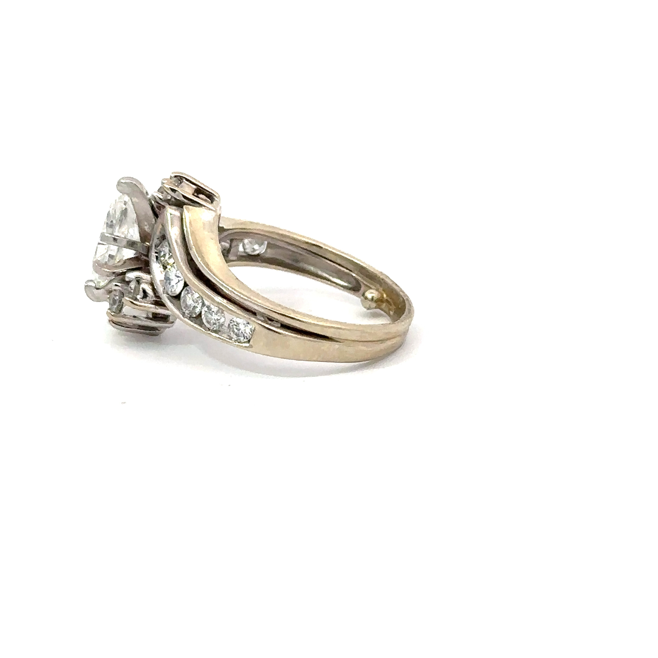 Side profile view of a 14kt white gold marquise engagement ring from John's Loan & Jewelry, featuring channel-set diamonds on a polished gold band.