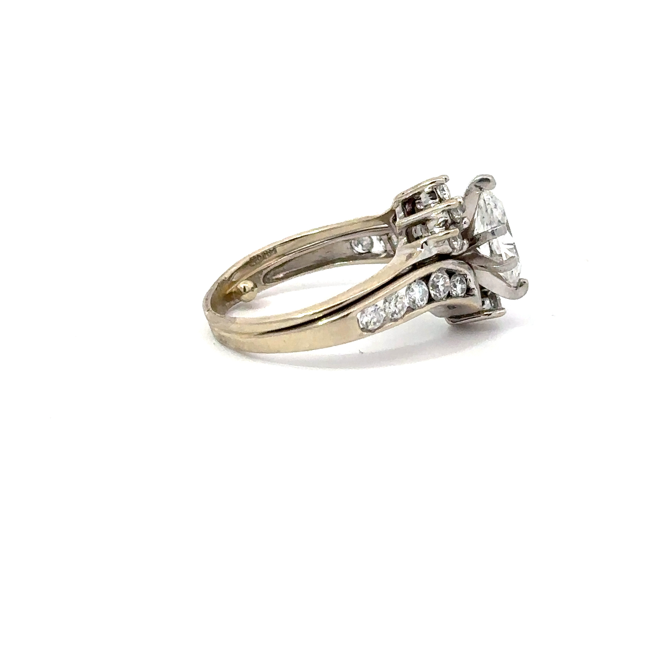 Detailed side shot of John's Loan & Jewelry 14kt white gold engagement ring, highlighting the marquise cut diamond and channel-set diamond details.