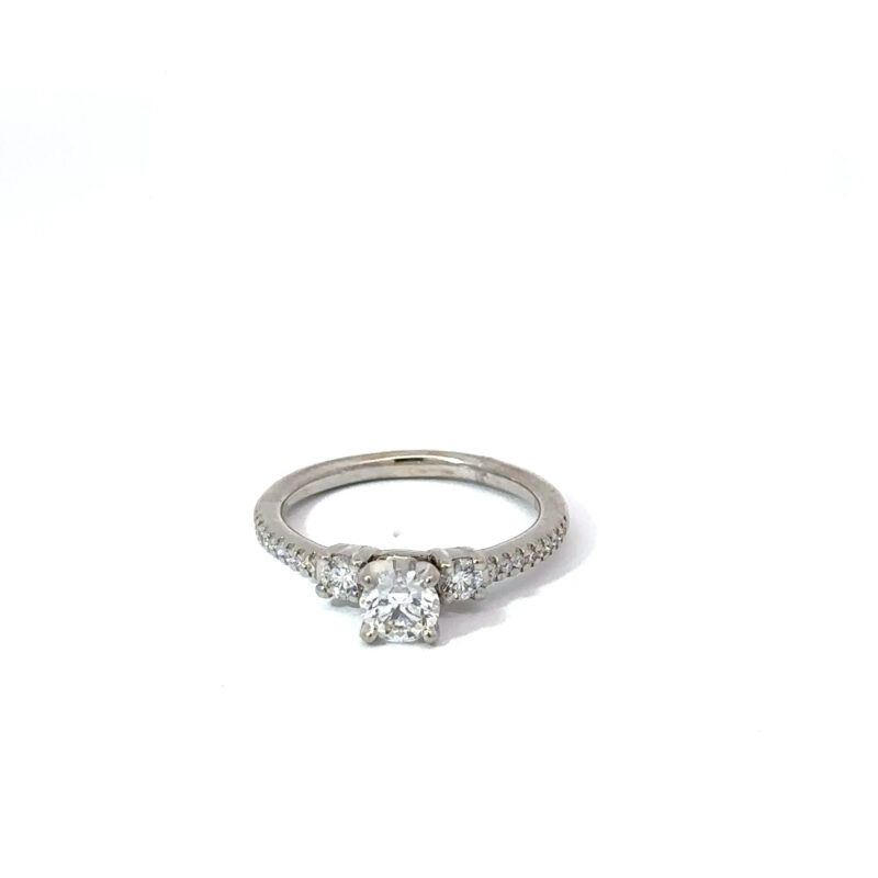Ladies' white gold engagement ring from John's Loan & Jewelry, featuring a .4ct round center diamond flanked by smaller accent diamonds set in a pavé style along the ring table.